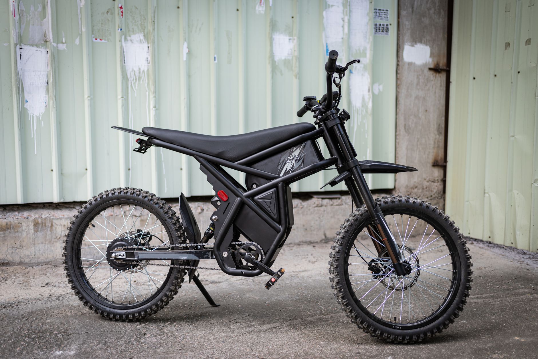 sleek black electric bike against industrial backdrop